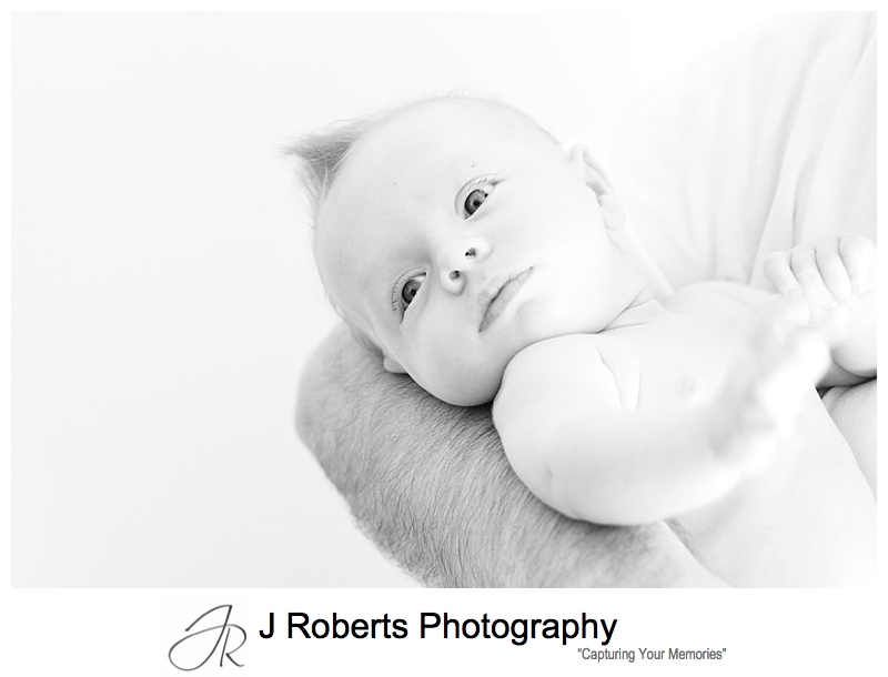 B&W portrait of a baby in her daddy's arms - sydney baby photographer
